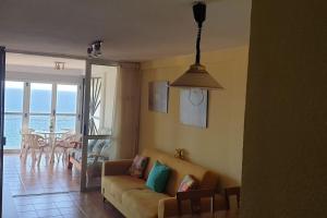 salon z kanapą i stołem w obiekcie Beautiful apartment with view on the sea with aircond. w mieście Benidorm