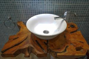 a bathroom with a sink on top of a wooden cut up tree stump at 401 APARTAMENTO NUEVO VISTA MAR con BALCÓN in Las Palmas de Gran Canaria