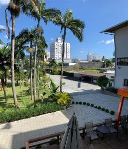 a view from the balcony of a resort with palm trees at Arco do Sol Park Hotel in Camboriú