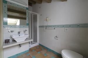 a bathroom with a sink and a toilet and a mirror at Hotel Villa Fanusa in Syracuse