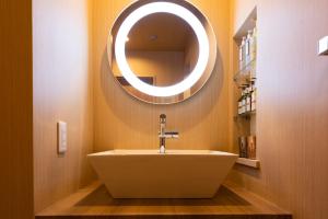a bathroom with a sink and a mirror on the wall at HOTEL ZEN-Adult Only in Hirosaki