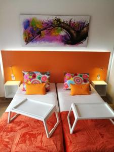 a bedroom with two beds and a painting on the wall at WiFi Costa Adeje in Adeje