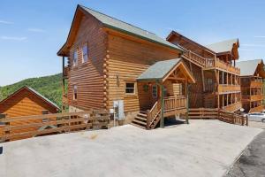 a log cabin with a large driveway in front of it at Heated Pool Hot Tub Game Room Mountain Views in Sevierville