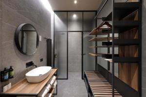 a bathroom with a sink and a mirror at Hotel Prokop Square in Prague