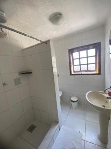 a bathroom with a shower and a sink and a toilet at pousada vida de Búzios recanto in Búzios