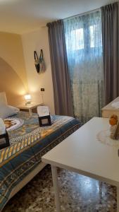 a room with two beds and a table and a window at Casa dei sospiri in Polignano a Mare