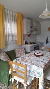 a room with a table and a kitchen with a table and chairs at Casa dei sospiri in Polignano a Mare