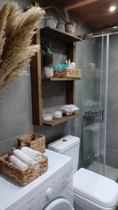 a bathroom with a toilet and a glass shower at Holiday House near Beach in Skala Fourkas