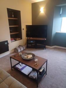 a living room with a couch and a coffee table at Hillview in Daliburgh