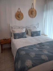 a bed in a bedroom with two baskets on the wall at Holiday House near Beach in Skala Fourkas