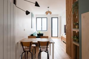 a kitchen and dining room with a table and chairs at Bright duplex near the center of Vincennes in Montreuil