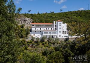 a large white building on top of a hill at Pure Monchique Hotel - by Unlock Hotels in Monchique