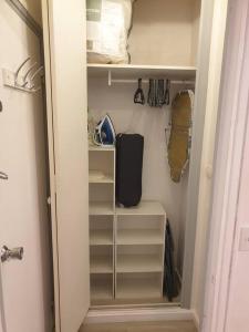 a walk in closet with a door open with shelves at Charmant studio avec place de parking in Nancy