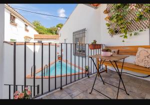 a balcony with a swimming pool on a white building at Fuente Vieja in Cortegana