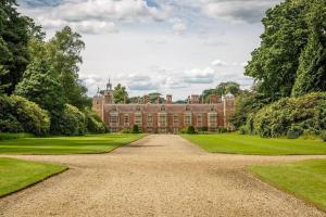 a large red brick mansion with a large driveway at The Garden House - Luxurious bolthole near coast in Banningham