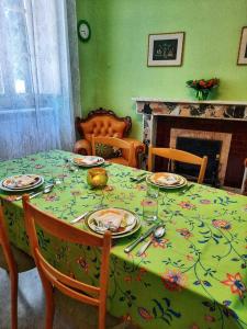 a dining room table with a flowered table cloth on it at Nonna Domenica - Casa Vacanze @Gagliano Aterno in Gagliano Aterno