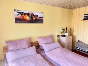 a bedroom with two beds and a picture of an elephant at Ferienwohnung Beyer Friedrichroda in Friedrichroda