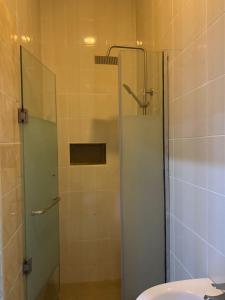 a bathroom with a glass shower with a sink at Luxury 1 Bedroom & Parlor Service Apartment with beautiful Amenities in Awoyaya