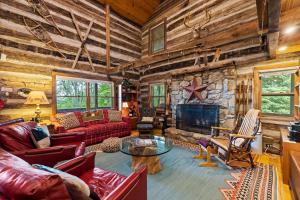 a living room filled with furniture and a stone fireplace at Logs Of Luxury Cabin - Golfers Dream in Swiss