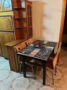 a dining room table with chairs in a kitchen at Valsamo Luxury Cottage in Chaïdeftón +24 photos