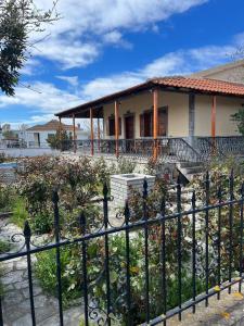 a house with a fence in front of it at Valsamo Luxury Cottage in Chaïdeftón