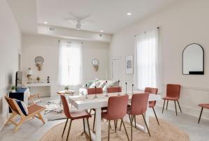 a white living room with a table and chairs at 5 BR home in Downtown Colonial Beach in Colonial Beach