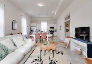 a living room with a white couch and a table at 5 BR home in Downtown Colonial Beach in Colonial Beach