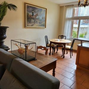 a living room with a couch and a table at Maison avec jardin et parking, au centre d'Etretat in Étretat