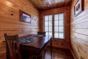 a dining room with a table and chairs in a log cabin at Suite Lookout At The Mentone Mountain View Inn in Mentone