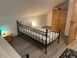 a bedroom with a bed and a wooden dresser at Monteursunterkunft Egenhofen in Egenhofen