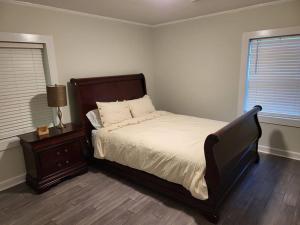 a bedroom with a bed and a night stand and a window at 5. Cozy cabin in Guntersville in Guntersville