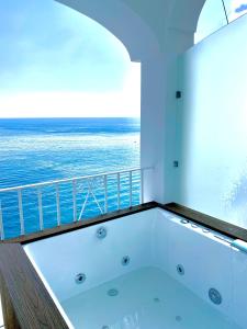 a bath tub with a view of the ocean at Villa Nina in Positano