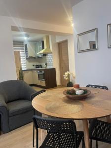 a living room with a table and a kitchen at ROMAN Residence Apartment in Borşa