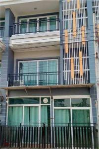 un edificio con balcón con reloj en Thanyaporn Guest House - Don Mueang en Thung Si Kan