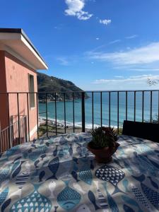 a table on a balcony with a view of the ocean at Ocean View Flat with WI-FI, AC and Elevator to Town in Levanto