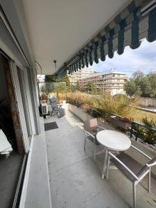 a balcony with a table and chairs on a building at La Garde d'Antoine - Appartement centre ville in La Garde