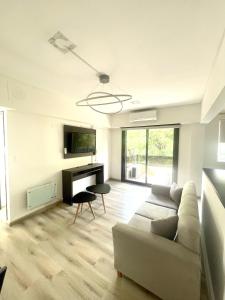 a living room with a couch and a desk at Golf Tower Suites & Apartments in Buenos Aires