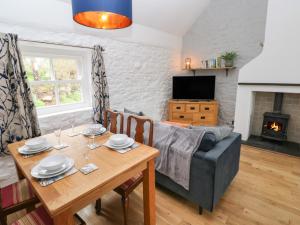 a living room with a table and a couch at Sands Cottage in Haverfordwest