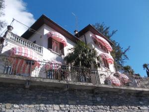 ein weißes Haus mit Balkon auf einem Gebäude in der Unterkunft Villa Varenna in Varenna