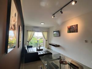 a living room with a couch and a window at Pacifico Apart Hotel in Santa Cruz de la Sierra