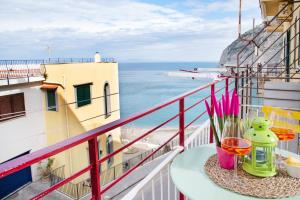 a balcony with a table with a view of the ocean at Luigi's room - De Vivo Realty Meta di Sorrento in Meta