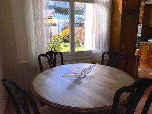 a wooden table with a napkin on top of it at Maison avec jardin et parking, au centre d'Etretat in Étretat