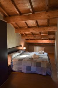 1 dormitorio con 1 cama en una habitación con techos de madera en Casa Rural Martín en Tronchón