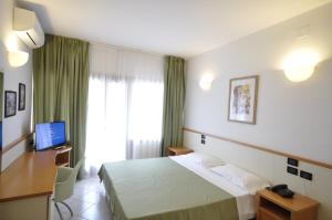 Postel nebo postele na pokoji v ubytování Hotel degli Ulivi