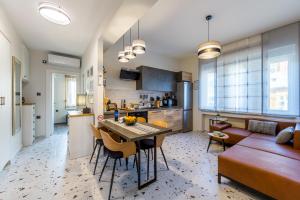 a kitchen and living room with a table and chairs at Sylvia suite@Kantrida in Rijeka