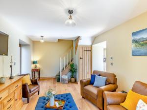 a living room with two chairs and a couch at The Mill in Llandegley