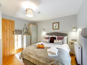 a bedroom with a large bed with a bag on it at The Mill in Llandegley