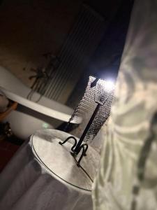 a table with a light on it next to a tub at Corte Dei Folletti in Lucca