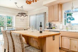 a kitchen with a table with a bottle of wine on it at Hilltop Heaven in Atascadero +49 photos