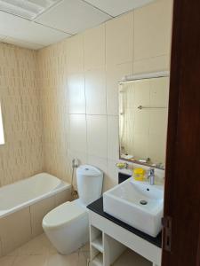 a bathroom with a white toilet and a sink at Diamond Room in Shared Apartment in Ajman 